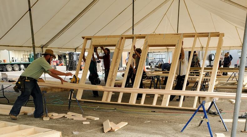 Members of Disaster Aid Ohio, an Amish relief group from Holmes County, assemble exterior and interior walls for homes being constructed in Dayton. CONTRIBUTED PHOTO