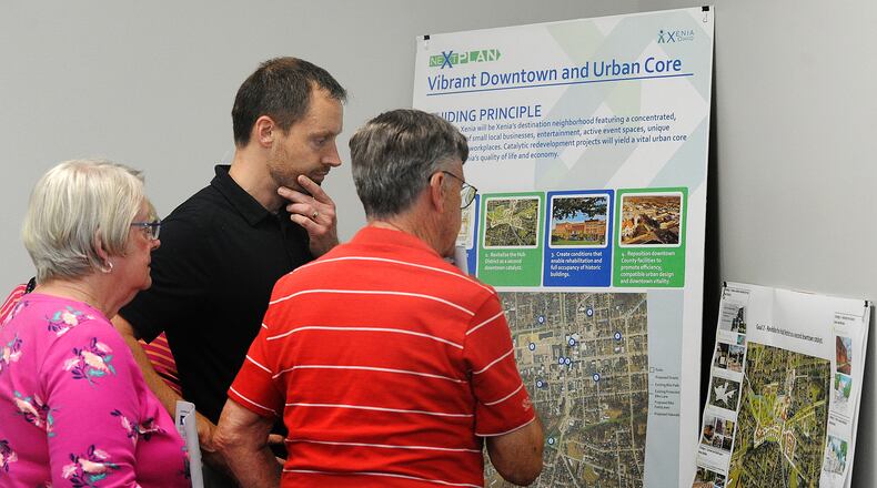 Xenia City Planner Brian Forschner, center, talks with residents about "neXtPlan" (a 10-year roadmap for Xenia development) at an open house Tuesday, April 16, 2024 at the Greene County media room. MARSHALL GORBY\STAFF