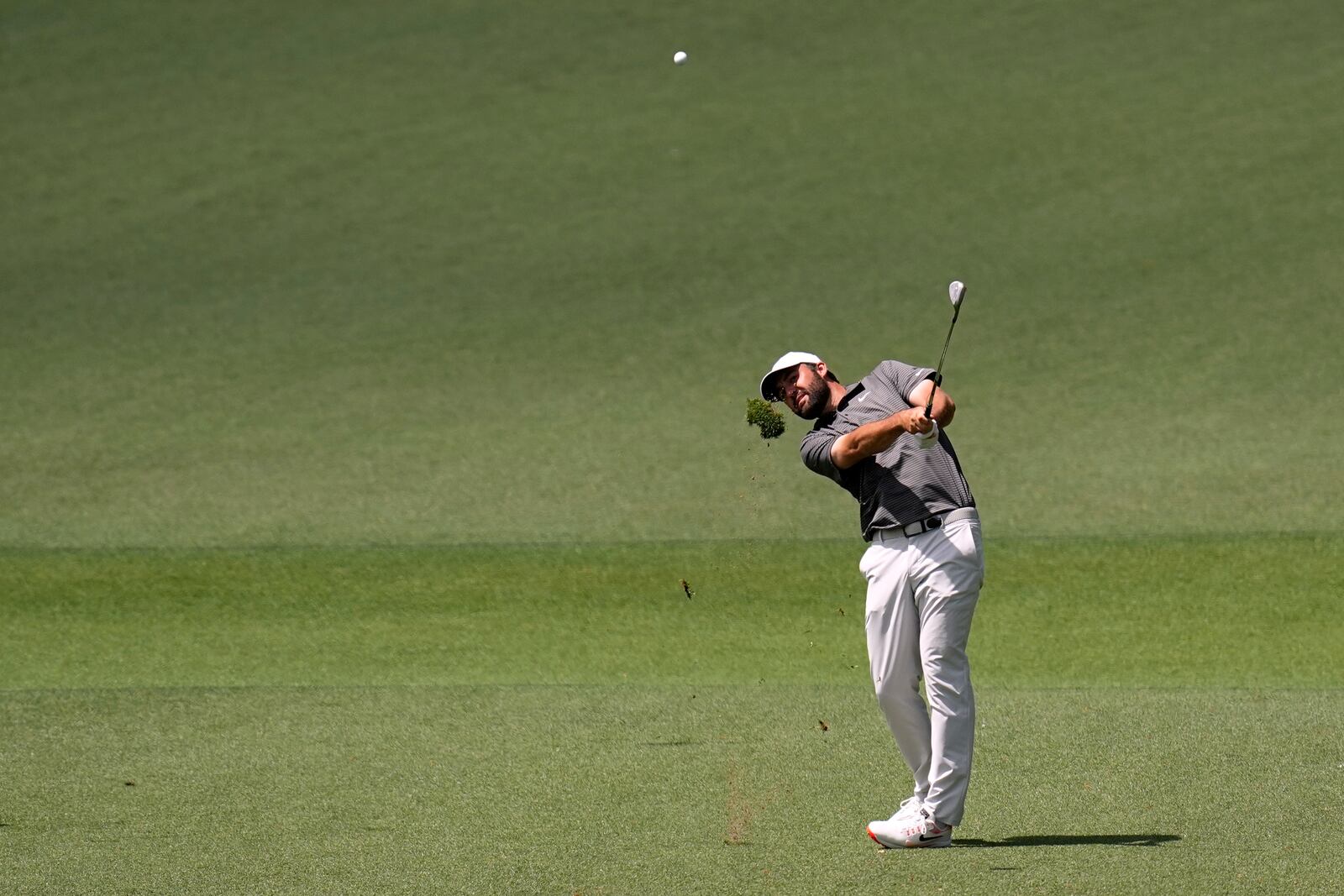 Scottie Scheffler hits from the fairway on the second hole during the third round at the Masters golf tournament, Saturday, April 12, 2025, in Augusta, Ga. (AP Photo/David J. Phillip)