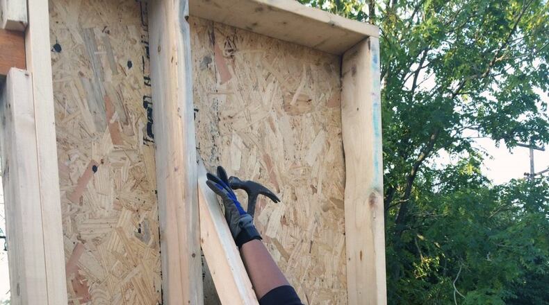 Workers put the finishing touches on a Habitat for Humanity home project in November. Habitat for Humanity of Greater Dayton will receive a $225,000 grant from the Federal Home Loan Bank of Cincinnati to construct eight and acquire and rehab two single-family homes in Dayton for low-income, first-time homebuyers. Photo/Provided