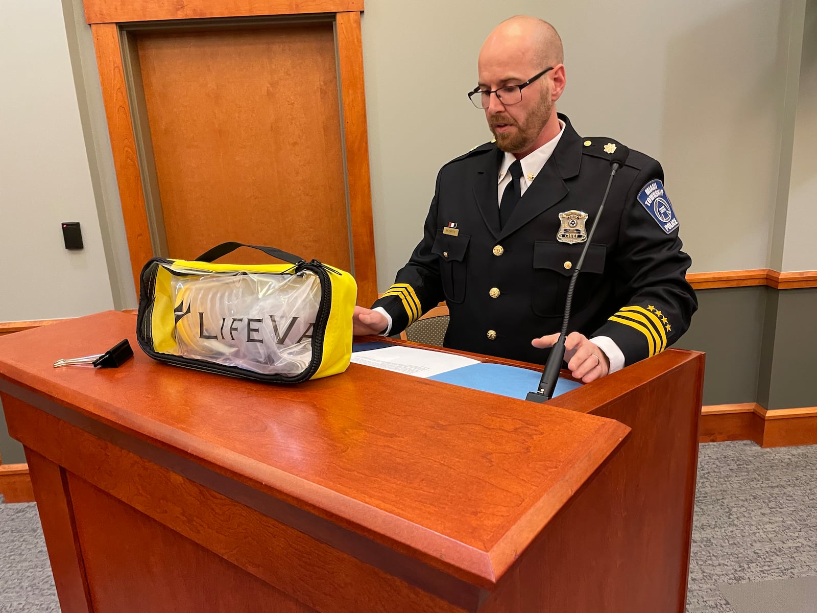 Miami Twp. Police Department Acting Chief James McCarty shows off a LifeVac anti-choking device during a Miami Twp. Board of Trustees meeting Tuesday, April 15, 2025. MTPD purchased the device for each of its cruisers after three officers saved the life of a 6-year-old who was choking. CONTRIBUTED