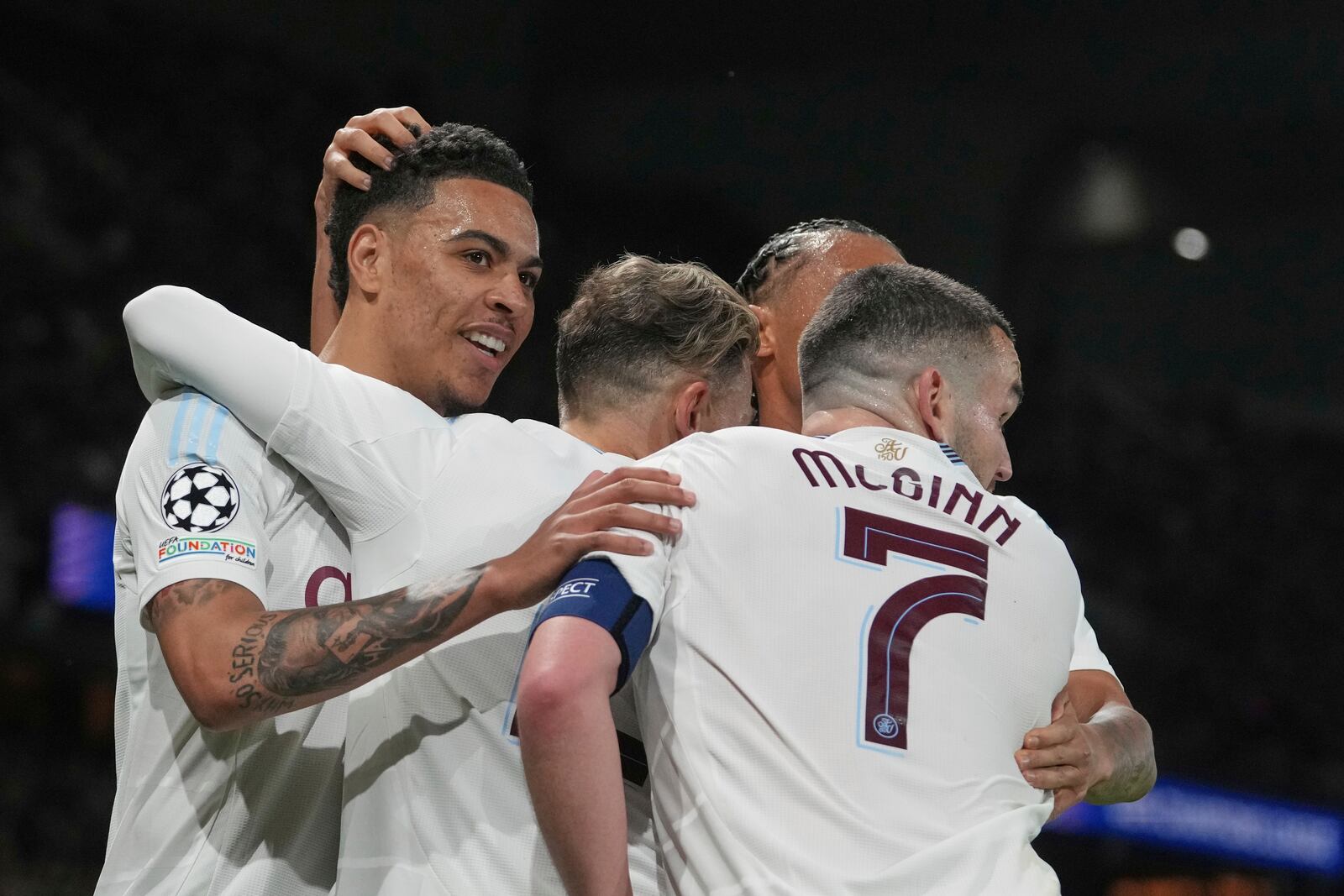 Aston Villa's Morgan Rogers, left, celebrates after scoring his side's opening goal during the Champions League quarterfinal first leg soccer match between Paris Saint-Germain and Aston Villa at Parc des Princes stadium in Paris, Wednesday, April 9, 2025. (AP Photo/Thibault Camus)