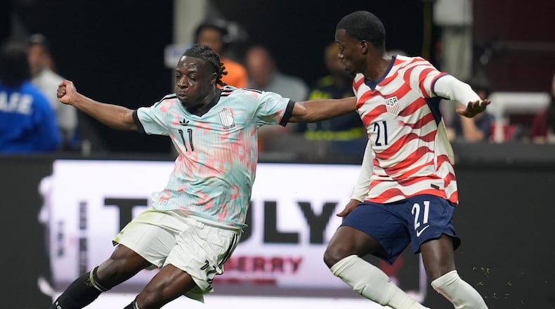 Belgium's Jeremy Doku moves against the United States' Timothy Weah (21) during an international friendly soccer match, Saturday, March 28, 2026, in Atlanta. (AP Photo/Mike Stewart)