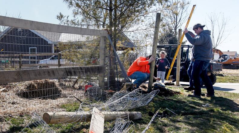 Along with about 30-feet of fencing, Debbie and Les Vaughn said the only tree on their Harrison Twp. property not damaged by a Memorial Day tornado was struck by driver who was shot by a Montgomery County Sheriff’s deputy on Saturday and died at the scene. CHRIS STEWART / STAFF