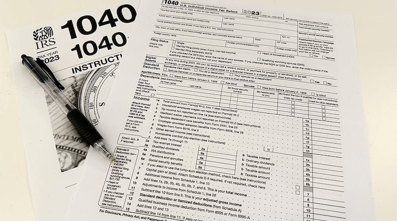 An Internal Revenue Service 2023 1040 tax form and instructions are shown on Friday, Jan. 26, 2024. For many people filing U.S. tax returns — especially those doing it for their first time — it can seem like a daunting task. (AP Photo/Peter Morgan)