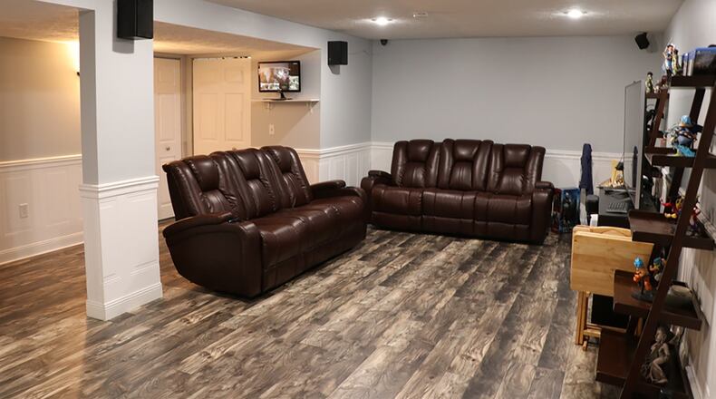 The basement has been finished into a recreation room. There are 2 bonus rooms with closets, and the wood-laminate flooring fills all 3 rooms, including the third full bathroom. The bath has a shower and single-sink vanity.