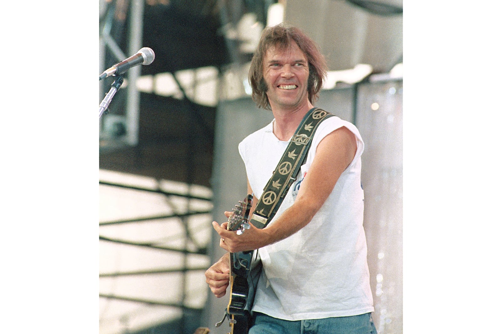 FILE - Neil Young performs during the Live Aid concert for famine relief at JFK Stadium in Philadelphia on July 13, 1985. (AP Photo/George Widman, File)