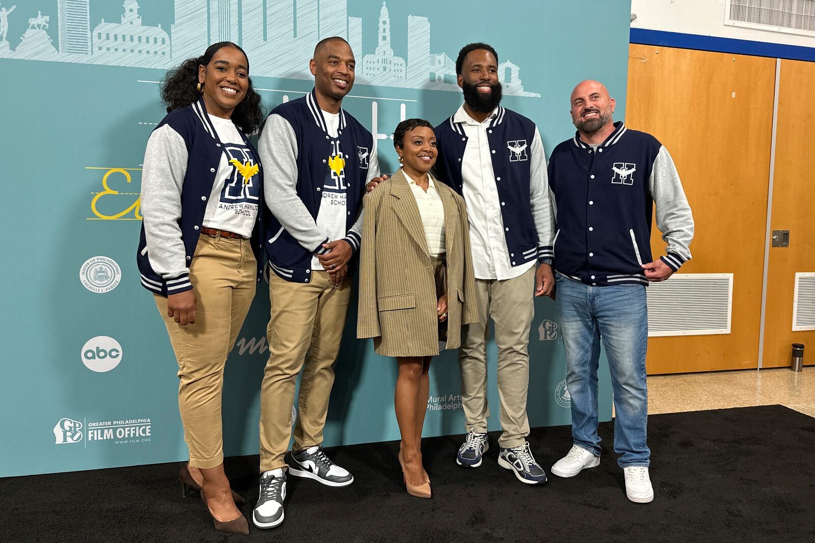 Actor Quinta Brunson, center, poses with unidentified teachers, before receiving a key to the city in a ceremony dedicating a mural at Brunson’s alma mater, Andrew Hamilton School, which was the inspiration for her award-winning show “Abbott Elementary”, Wednesday, May 28, 2025, in Philadelphia. (AP Photo/Tassanee Vejpongsa)