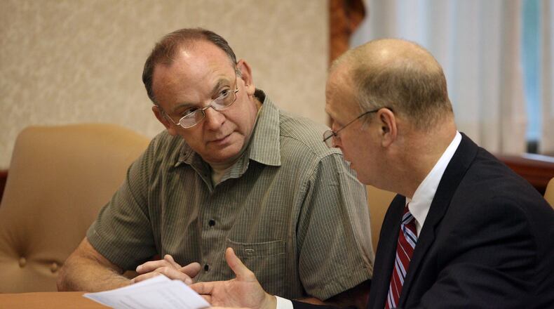 Raymond Tanner, talks with his attorney Greg Howard, who is now a Butler County Common Pleas judge, during a hearing Friday, Sept. 25, 2009, where he was ordered to remain under court control by Butler County Common Pleas Judge Andrew Nastoff. Tanner was found not guilty by reason of insanity after decapitating his wife on Valentine s day in 1990. FILE