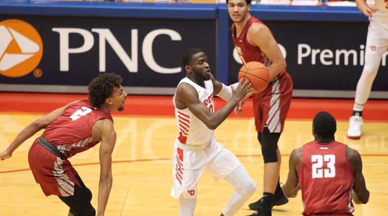 Dayton’s Jalen Crutcher passes against Saint Joseph’s on Tuesday, Jan. 29, 2019, at UD Arena. David Jablonski/Staff