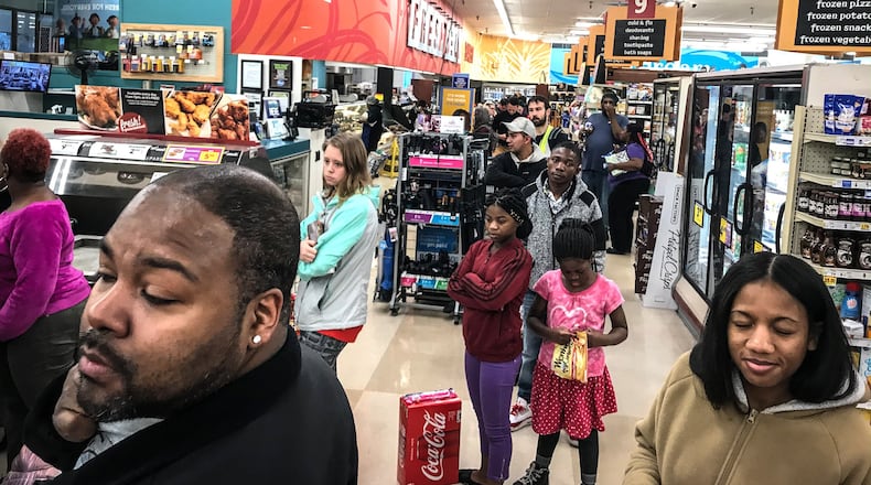 Shoppers at the Kroger’s on Wayne Ave. waited in line over a half and hour to get provisions Thursday night. Because of the coronavirus, the City of Dayton issued a state of emergency. JIM NOELKER/STAFF