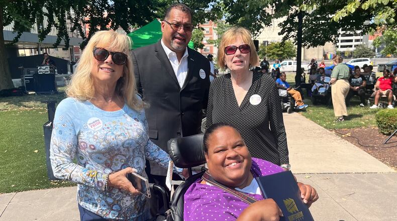 County Commissioner Debbie Lieberman (middle left), County Commissioner Judy Dodge (middle right), City Commissioner Chris Shaw (back), with Latisha Martin (front), a 2022 keynote speaker for the rally. Martin is holding a proclamation issued by the Board of County Commissioners, recognizing and honoring those with disabilities.