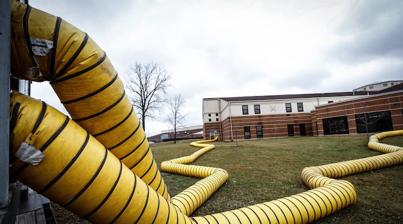 Large drying trucks are pumping air into the back of Springboro High School on Tuesday January 3, 2023. A sprinkler pipe burst around Christmas, flooding parts of the building. JIM NOELKER/STAFF