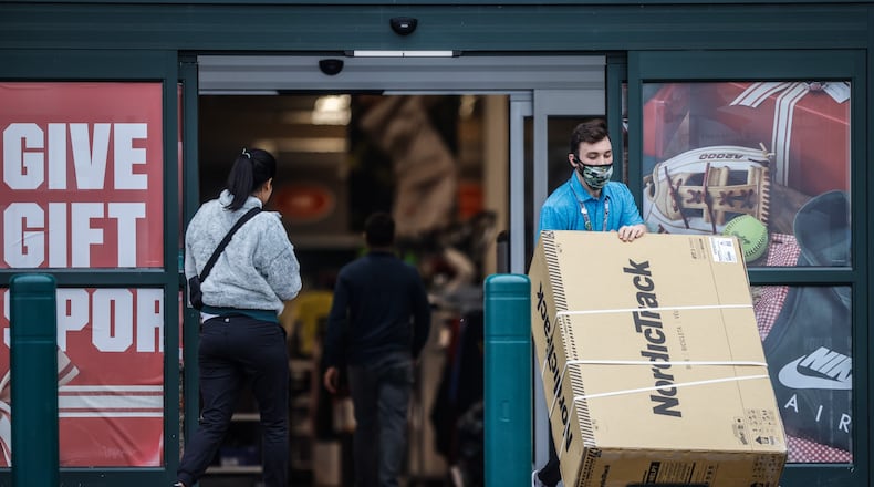 A Dick's Sporting Goods employee at the Dayton Mall moves an item to a customer's truck Thursday Dec 30, 2021. Holiday retail sales excluding automotive increased 8.5% year-over-year this holiday. JIM NOELKER/STAFF