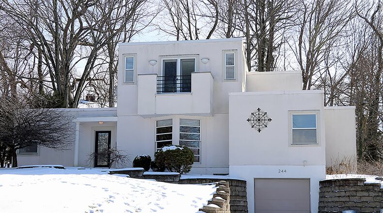 The stucco 2-story home has about 2,570 sq. ft. of living space, plus a finished basement. Using the natural landscape, the property has keystone accent garden walls and curving concrete steps that lead up to the front formal entry from the driveway. CONTRIBUTED PHOTO BY KATHY TYLER