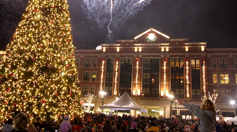 A display from Prestige Fireworks begins at the same time the tree comes on during the Santa parade and tree lighting celebration at The Greene towne square in Beavercreek, Saturday, November 19, 2011.