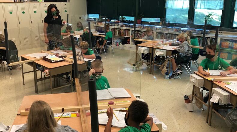 Second-graders in Carol Keating's classroom at St. Brigid's Catholic School in Xenia learn about synonyms Friday, Sept. 25, 2020.