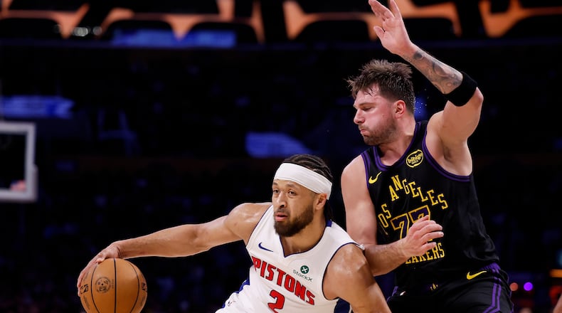 Detroit Pistons guard Cade Cunningham (2) looks to pass the ball while being guarded by Los Angeles Lakers guard Luka Doncic (77) during the first half of an NBA basketball game Tuesday, Dec. 30, 2025, in Los Angeles. (AP Photo/Caroline Brehman)