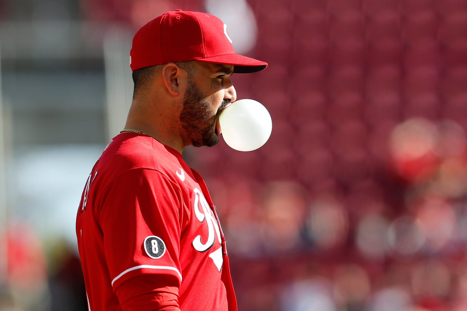 Cincinnati Reds' Eugenio Suarez blows a bubble while waiting for the next pitch against and Washington Nationals during the ninth inning of a baseball game Sunday, Sept. 26, 2021, in Cincinnati. The Reds defeated the Nationals 9-2. (AP Photo/Jay LaPrete)
