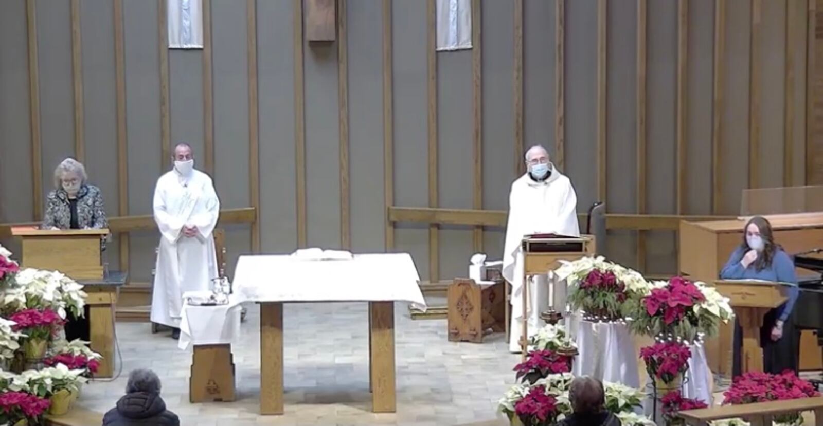 Fr. Jim Fitz (second from right) celebrates Catholic Mass at St. Helen Church in Riverside on Jan. 10.