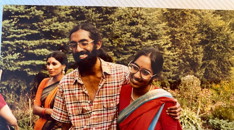 Tejaswini Rao chats with party guests while Subramanyam and Saraswathi Vedam embrace during their parents' wedding anniversary party at State College, Pa., in August 1981. (Saraswathi Vedam via AP)