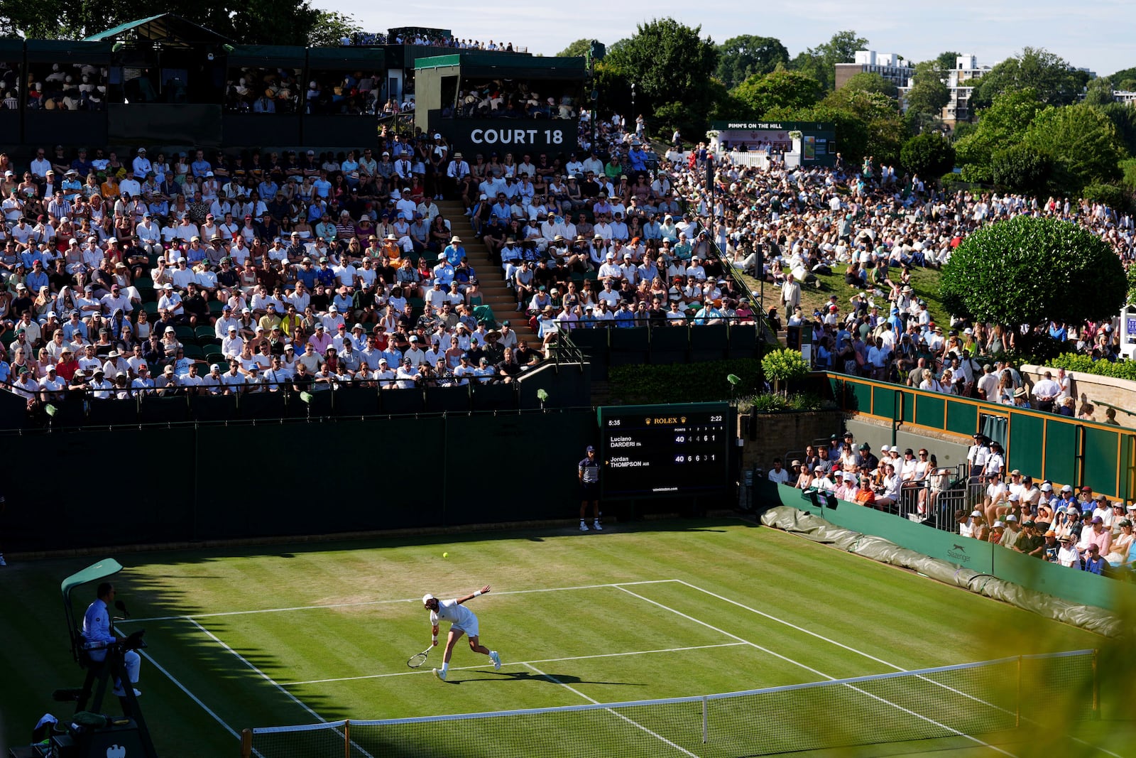 Australia's Jordan Thompson returns during his match against Italy's Luciano Darderi during their men's singles third round match on day five of the Wimbledon Tennis Championships in London, Friday July 4, 2025. (Ben Whitley/PA via AP)