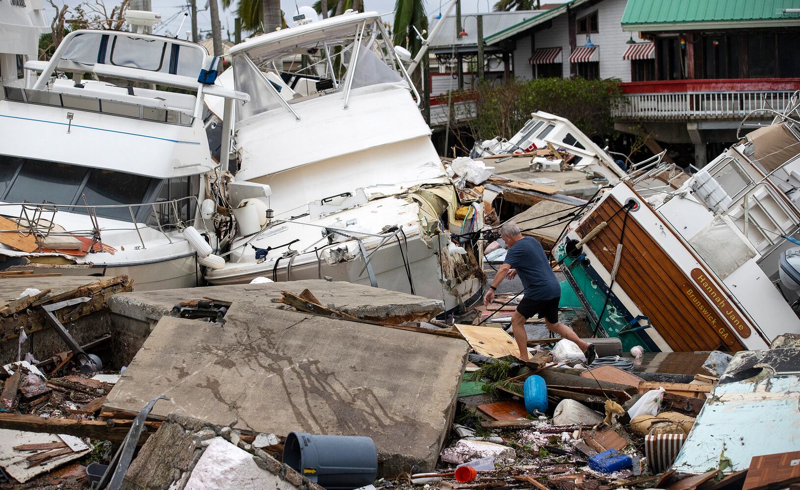 James Grey looks for his house boat along the Caloosahatchee River in downtown Fort Myers, Fla. on Thursday, Sept. 29, 2022. (Kinfay Moroti/The New York Times)