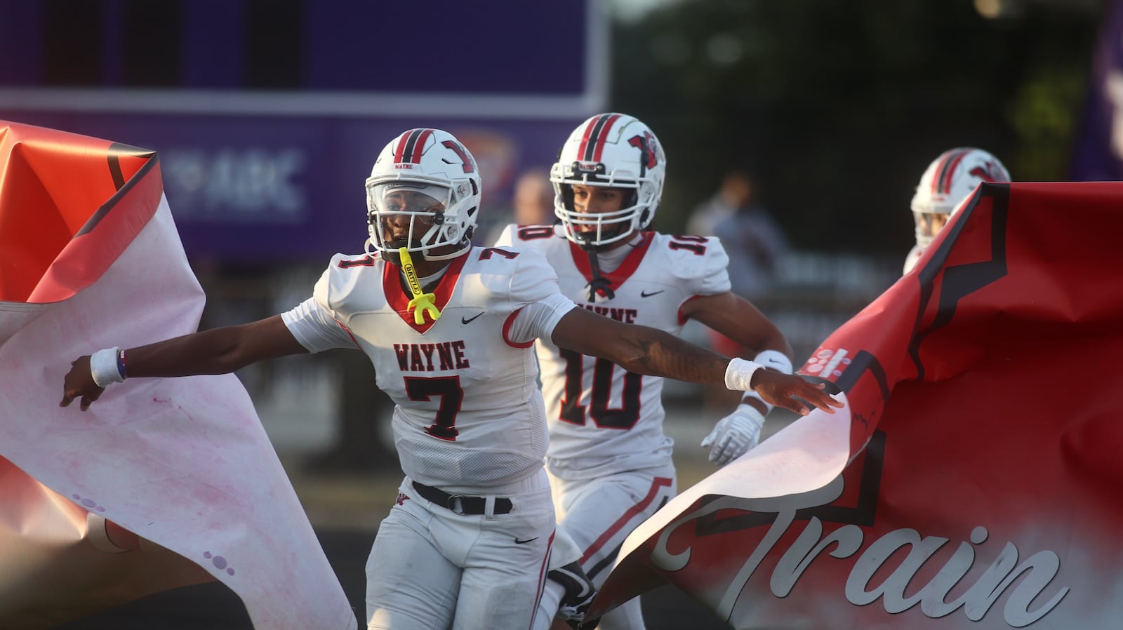 Wayne's Kye Graham leads the team onto the field before a game against Pickerington Central on Friday, Aug. 29, 2025, in Pickerington. David Jablonski/Staff