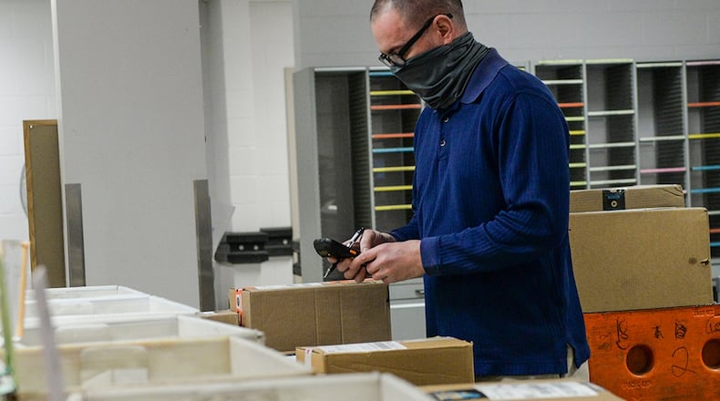 Jeremy Hamiel, a mail clerk with the 88th Force Support Squadron Official Mail Center, scans a package into the Official Mail Center before sending it out for delivery at Wright-Patterson Air Force Base on Feb. 8. The center is responsible for handling all official mail coming to and going from Wright-Patt organizations. U.S. AIR FORCE PHOTO/WESLEY FARNSWORTH
