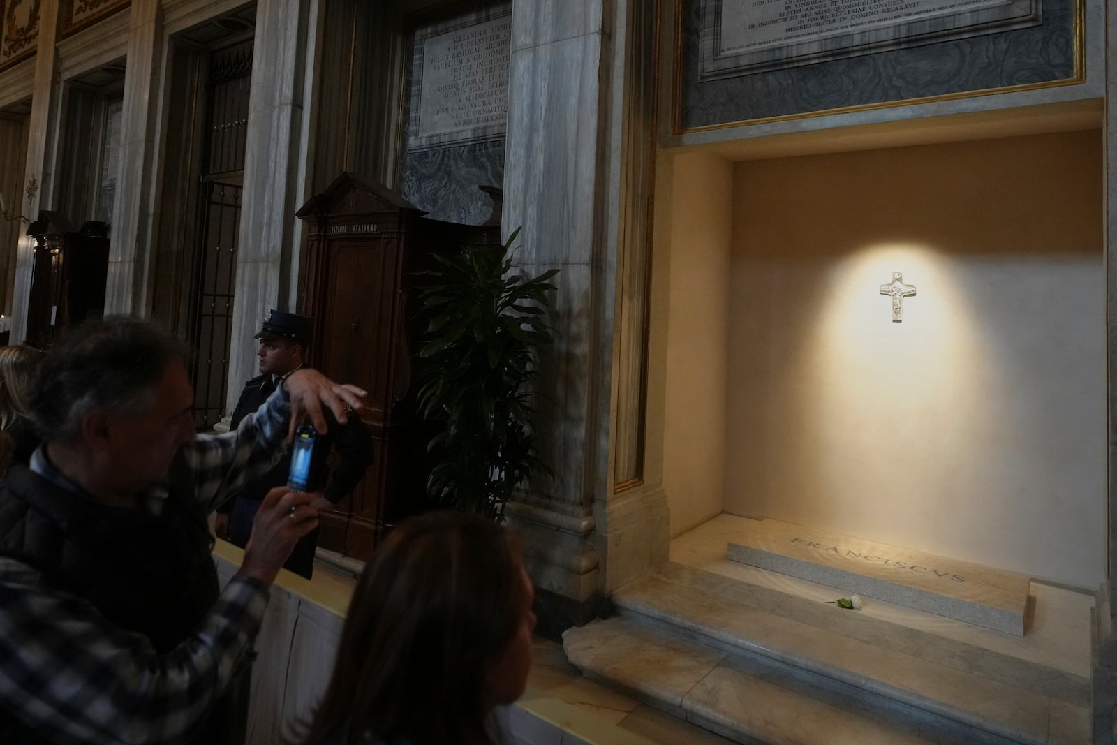 A man takes images of the tomb of Pope Francis as faithful are allowed inside St. Mary Major Basilica in Rome, Sunday, April 27, 2025. (AP Photo/Alessandra Tarantino)