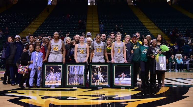 Wright State’s four seniors (from left) Imani Partlow, Mackenzie Taylor, Emily Vogelphol and Symone Simmons are joined by friends and family after Sunday’s Senior Day win over Youngstown State at the Nutter Center. Joseph Craven/CONTRIBUTED