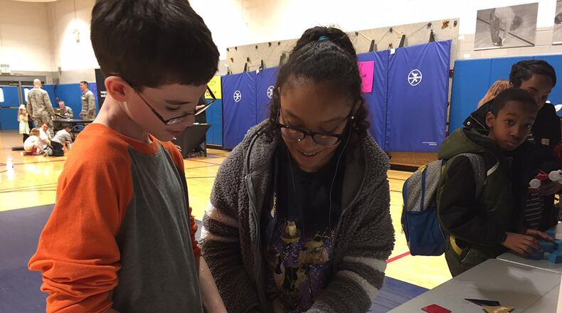 Nathan Smith and Adrielle Tolentino examine how to engineer a cube during STEM 3.14 Fest at the Youth Center at Wright-Patterson Air Force Base March 14. (Skywrighter photos/Amy Rollins)