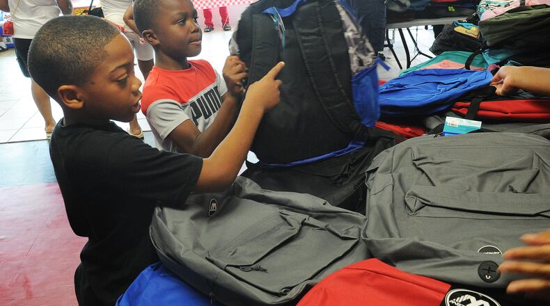 Exclusively Curved & Ladybug Delivery gave away over 350 backpacks full of school supplies Friday, Aug. 6, 2021. The business is located at 4823 Salem Ave. in Trotwood. MARSHALL GORBY\STAFF.