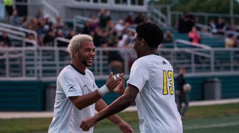 Wright State’s Austin Kinley (left) and Alex Phillipe celebrate after Phillipe’s goal against Duquense on Sept. 25, 2018. Joseph Craven/CONTRIBUTED