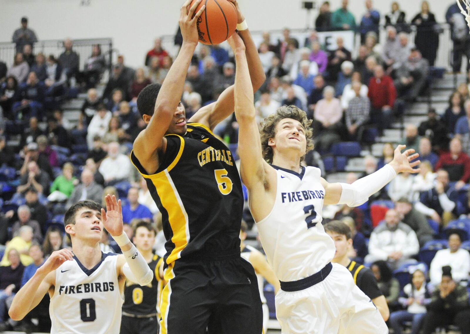 Mo Njie of Centerville (middle) takes a rebound away from Kellan Bochenek of Fairmont. Centerville defeated Fairmont 46-44 in a boys high school basketball game at Trent Arena on Friday, Feb. 8, 2019. MARC PENDLETON / STAFF