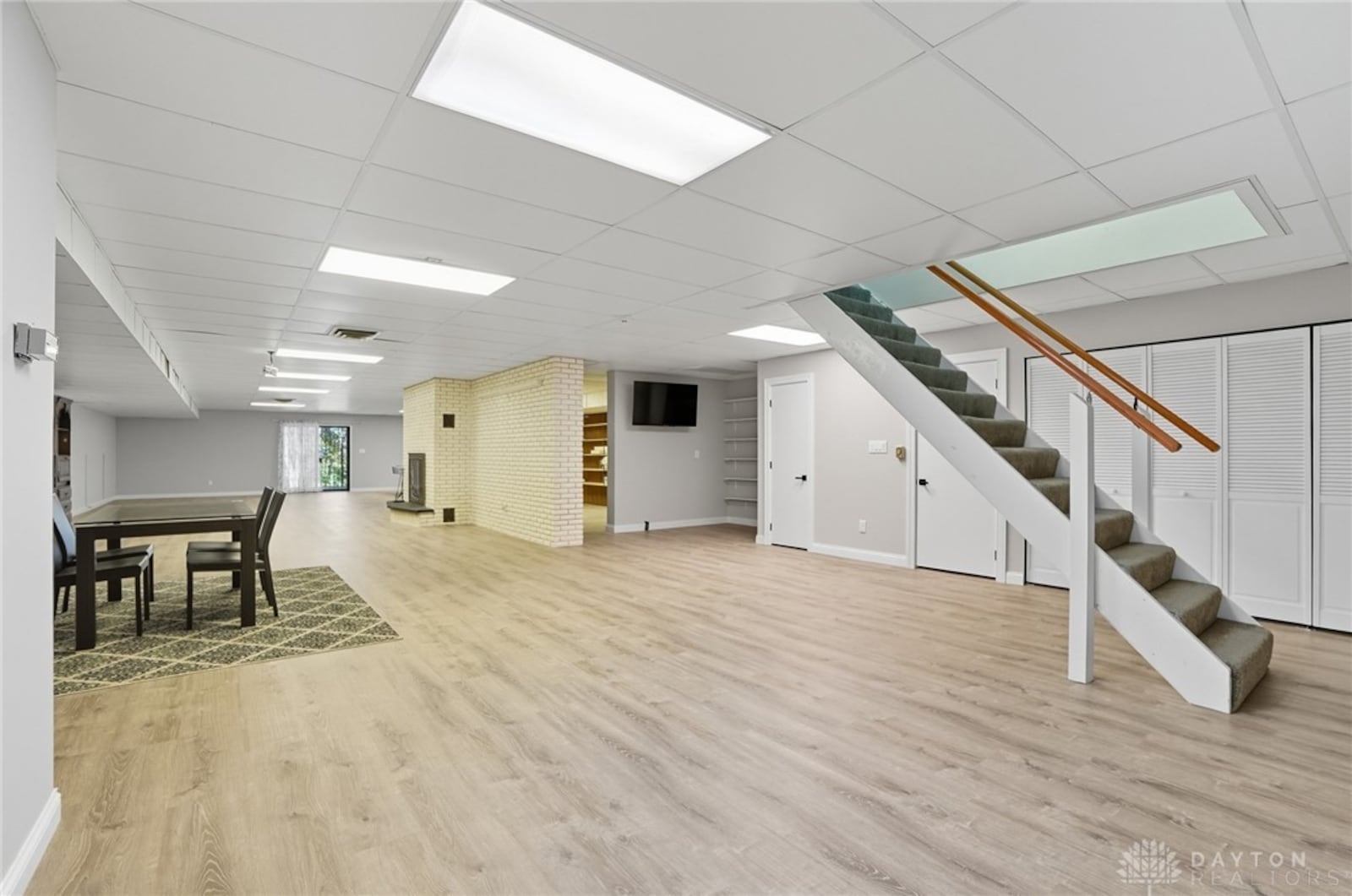 The finished walkout basement has a recreation room with LVT flooring and a woodburning fireplace. It also has storage areas. CONTRIBUTED