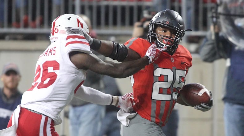 Ohio State’s Mike Weber fends off Nebraska’s Kieron Williams on a touchdown run in the first half on Saturday, Nov. 5, 2016, at Ohio Stadium in Columbus. David Jablonski/Staff