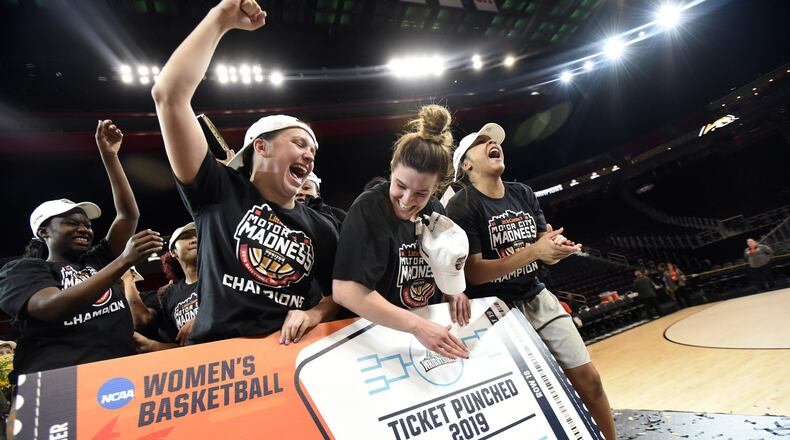 The Wright State women’s basketball team, including seniors (center) Mackenzie Taylor and Emily Vogelpohl, celebrate a win over Green Bay in the Horizon League championship game on Tuesday at Little Caesars Arena in Detroit. Jose Juarez/CONTRIBUTED