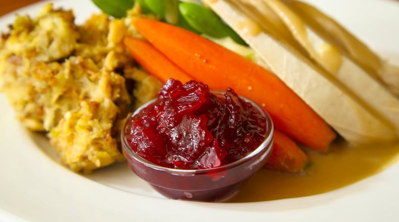 The Golden Lamb Roasted Turkey Breast entree, with onion-sage dressing, whipped yukon potatoes, carrots, green beans, and orange-cranberry relish. GREG LYNCH / STAFF