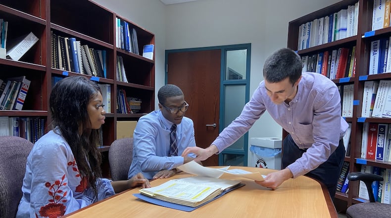 Montgomery County Environmental Services Engineer David Swanson, standing, works with interns Coria Richardson, left, and Bobby Gist on Feb. 13 in Kettering. Both interns are Central State University engineering students. Their internship is a result of a partnership between the county and CSU that calls for the university to conduct water management research and provide engineering student interns to work with the Montgomery County s Environmental Services. /ISMAIL TURAY JR.