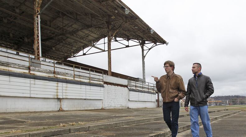 Students from Sinclair Community College civil engineering technologies program, Zachary Osterday, left, and Christopher Hess, talk about surveying work they completed at onMain - Dayton’s Imagination District during a two-semester lab project. TY GREENLEES / STAFF