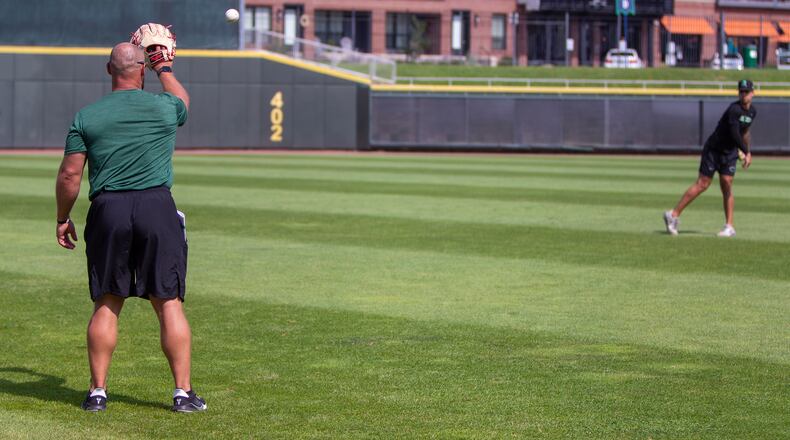 Dragons pitching coach Brian Garman tosses with Lyon Richardson the day after a start. Richardson said he is learning to be a better pitcher this summer under Garman's direction. Jeff Gilbert/CONTRIBUTED