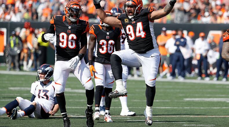 CINCINNATI, OH - SEPTEMBER 25: Carlos Dunlap #96 of the Cincinnati Bengals and Domata Peko #94 of the Cincinnati Bengals celebrate after making a defensive stop during the third quarter of the game against the Denver Broncos at Paul Brown Stadium on September 25, 2016 in Cincinnati, Ohio. (Photo by Joe Robbins/Getty Images)