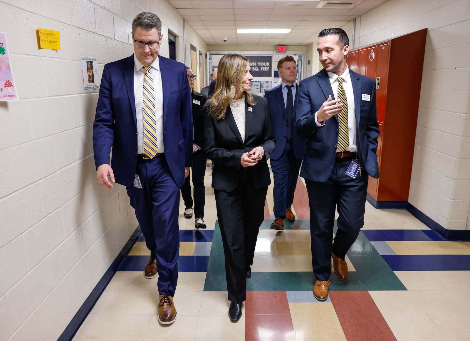 Monroe Local Schools superintendent, Robert Buskirk, left, and Monroe Junior High principal, Logan Stanger, right, walk the hall with Democrat Ohio gubernatorial candidate Amy Acton as she tours Monroe Local Schools Wednesday, Jan. 14, 2026 in Monroe. She visited classrooms and spoke with students, teachers and leadership during the tour. NICK GRAHAM/STAFF