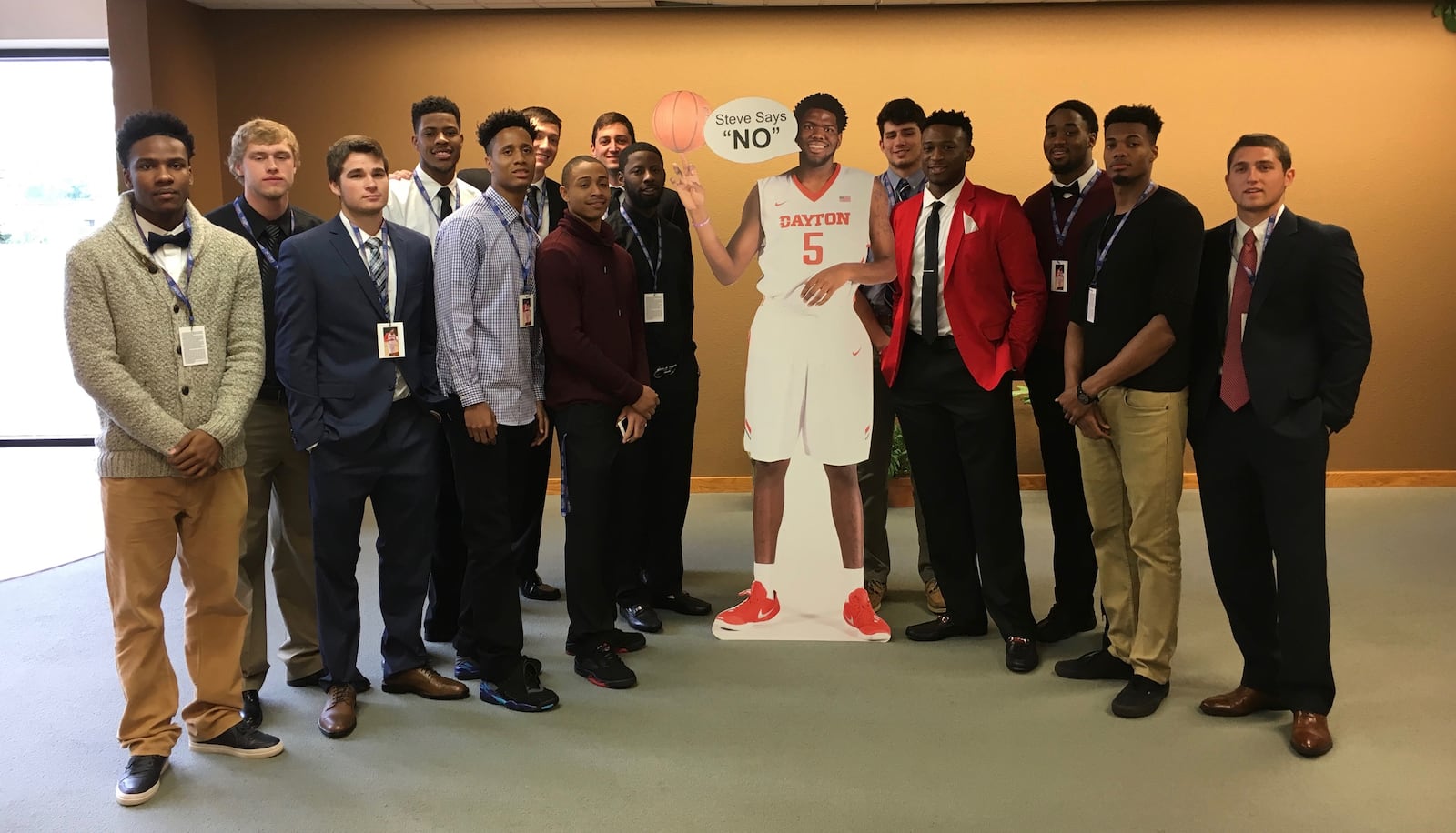 Dayton men's basketball players pose with a cardboard cutout of Steve McElvene before McElvene's funeral on Saturday, May 21, 2016, at Abundant Life Church in Fort Wayne, Ind. David Jablonski/Staff