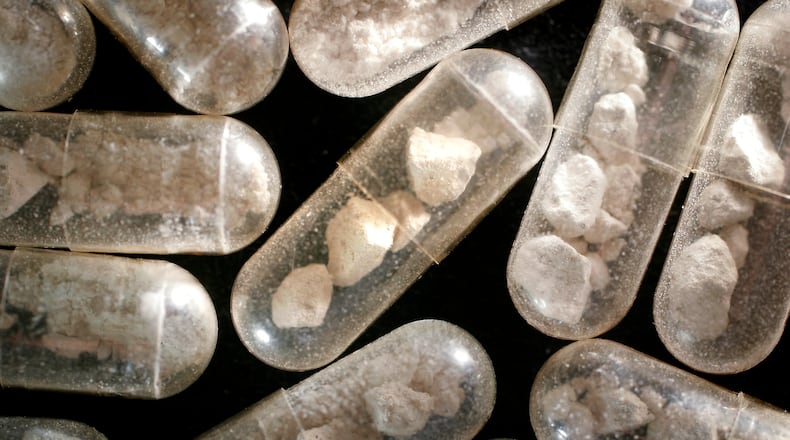 Gelatin capsules are seen filled with heroin at the Montgomery County Crime Lab. Staff photo by Chris Stewart