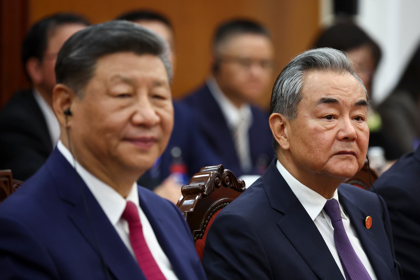 Chinese President Xi Jinping, left, and Foreign Minister Wang Yi attend a meeting with Vietnam's National Assembly Chairman Tran Thanh Man, not pictured, during a two-day state visit, in Hanoi, Vietnam, Monday April 14, 2025. (Athit Perawongmetha/Pool Photo via AP)