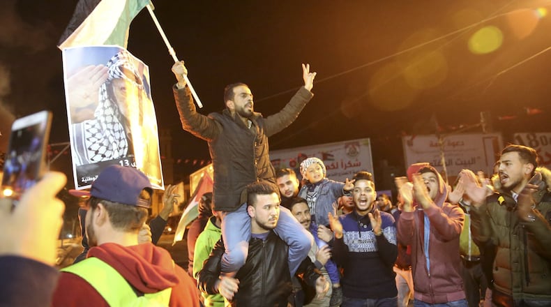 Palestinian protestors chant slogans as they wave their national flags and pictures of late Palestinian president Yasser Arafat during a protest at the main Square in Gaza City, Wednesday, Dec. 6, 2017. Defying worldwide warnings, U.S. President Donald Trump on Wednesday broke with decades of U.S. and international policy by recognizing Jerusalem as Israel’s capital.(AP Photo/Adel Hana)