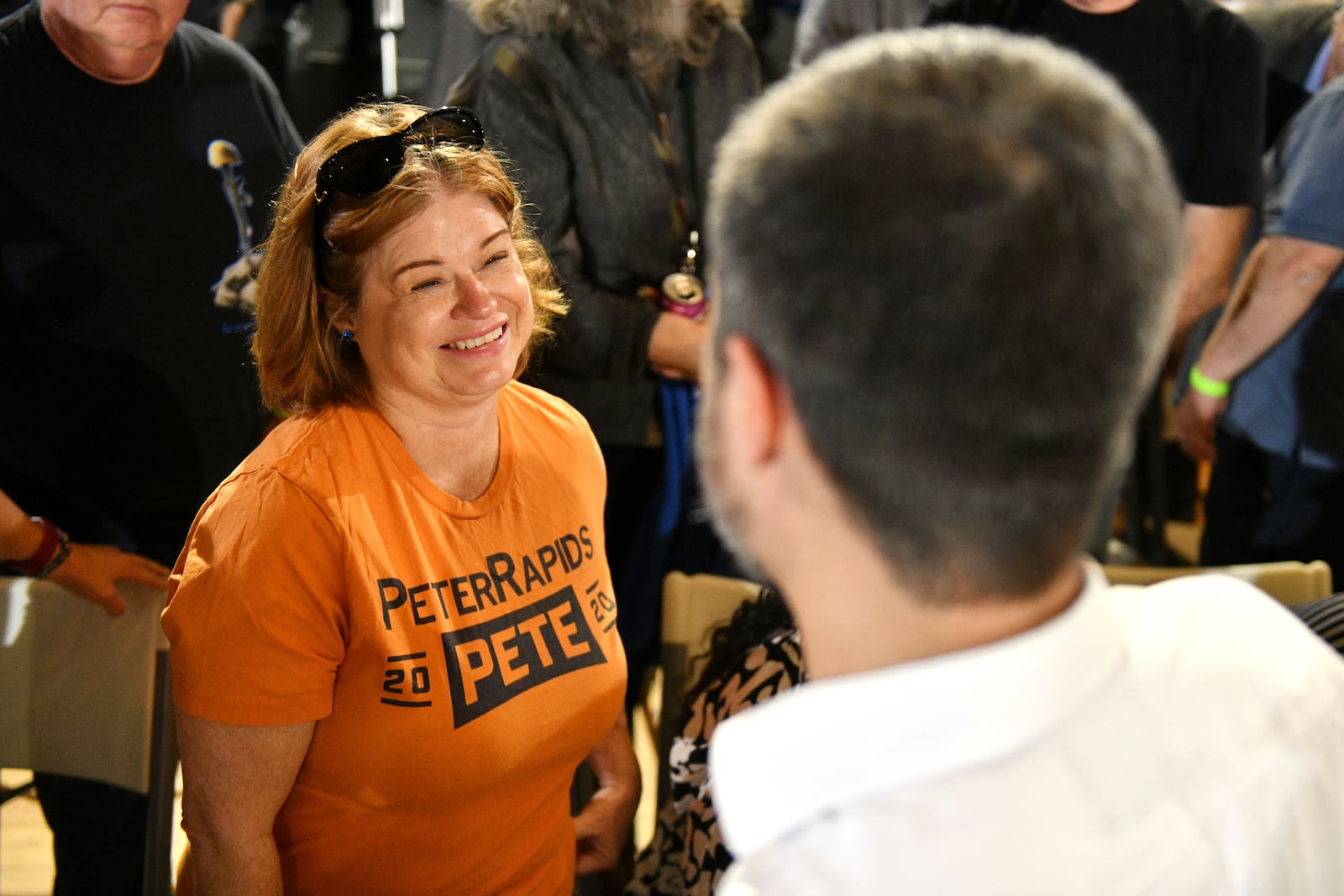 Brenda Masters of Cedar Rapids, Iowa, greets former U.S. Secretary of Transportation Pete Buttigieg, wearing a t-shirt she made while volunteering for Buttigieg during the 2020 Iowa Caucus, during a VoteVets Townhall, Tuesday, May 13, 2025, in Cedar Rapids, Iowa. (AP Photo/Cliff Jette)