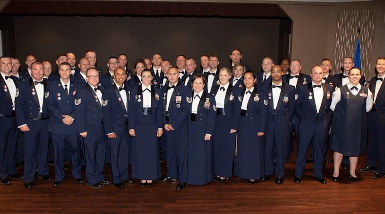 Col. Thomas Sherman (left), 88th Air Base Wing and installation commander, and Chief Master Sgt. Troie Croft (right), Air Force Life Cycle Management Center command chief, and Chief Master Sgt. Keelan Rasmusson superintendent (back right), 88th Air Base Wing Staff Agency, congratulate the newest Team Wright-Patt senior NCOs during an induction ceremony at the Wright-Patterson Club Aug 23. (U.S. Air Force photos/Michelle Gigante)